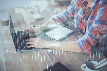 Multi exposure of forex graph with man working on computer on background. Concept of market...