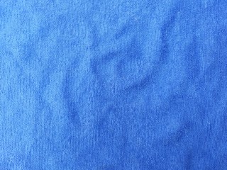 Texture background of blue cotton fabric that has wrinkles of fabric.