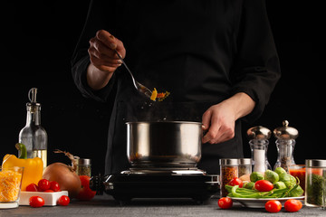 Cooking by the chef in the kitchen. Recipes and cooking, gastronomy. Culinary background. Italian pasta with ingredients.