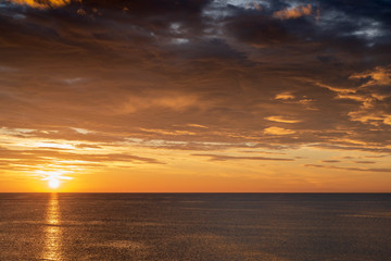 Early sunrise and epic cloudy sky above the sea. Coast of Torrevieja, Alicante, Spain. Mediterranean sea 2019