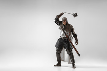 Brave armored knight with professional weapon fighting isolated on white studio background....