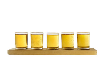 Yellow, same color opaque carbonated cocktails, a set of shots in one row, five servings on a wooden stand, substrate, Side view Isolated white background. Drink for the menu restaurant, bar, cafe