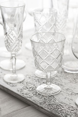 Empty champagne glasses in white grey shades on concrete background.