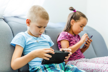 Preschool boys playing on smartphone