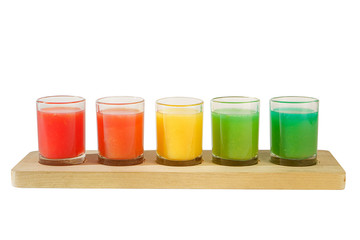 Multicolored opaque cocktails, a set of shots in one row, five servings on a wooden stand, substrate. Side view Isolated white background. Drink for the menu restaurant, bar, cafe