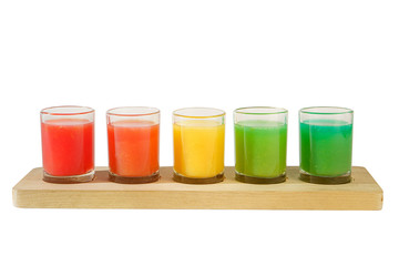 Multicolored opaque cocktails, a set of shots in one row, five servings on a wooden stand, substrate. Side view Isolated white background. Drink for the menu restaurant, bar, cafe
