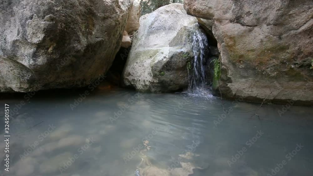 Wall mural River rolling in Avakas gorge among stones