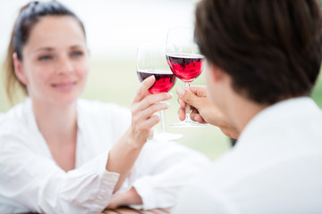 Young couple in love drinking red wine in a winery