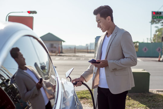 Man Charges Electric Car