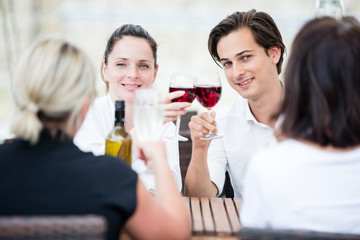 Group of friends drinking wine in a winery