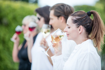 Group of people tasting wine in a winery