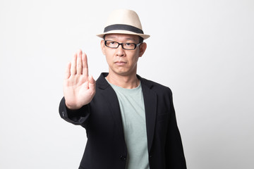 Portrait of an  adult asian man showing stop gesture.