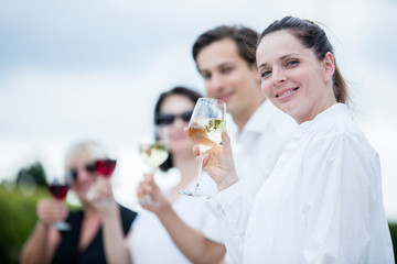 Group of people tasting wine in a winery