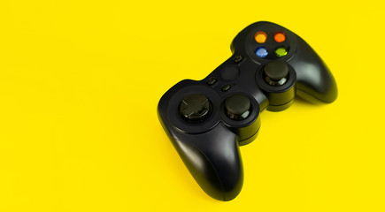 .Gamepad ( joystick)  for video games on a yellow background with space for text. Game, e-sport and gamer workspace concept. Banner format. © Nadya Vetrova