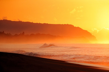 Fototapeta na wymiar Costa Rica holiday, sunrise. Orange dark red sunset. Beautiful evening twilight in the wild nature. Dramatic orange sky above tropic forest in Costa Rica. Ocean wave on the sand beach, Manuel Antonio.