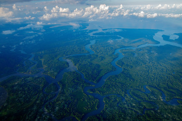 Fototapeta na wymiar River in tropic Costa Rica, Corcovado NP. Lakes and rivers, view from airplane. Green grass in Central America. Trees with water in rainy season. Photo from air.
