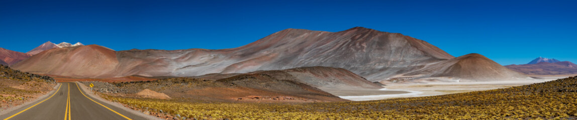 Super wide panorama of red stones and road