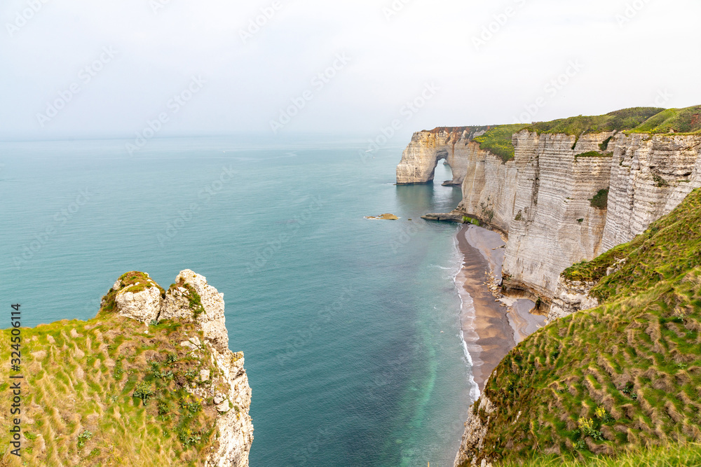 Wall mural Rocks on the coast of the English channel strait. Etretat village, Normandy region, France.