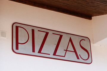pizzeria pizzas sign words painted on a restaurant shop wall of italian pizza food