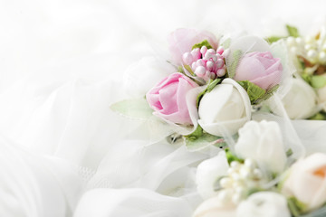 wedding flowers on bridal dress folds