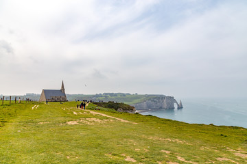 Rocks on the coast of the English channel strait. Etretat village, Normandy region, France.