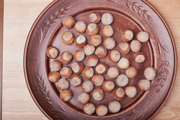 Walnut kernels and whole walnuts on rustic old wooden table