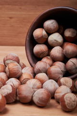 Walnut kernels and whole walnuts on rustic old wooden table