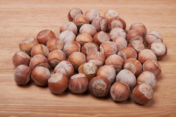 Walnut kernels and whole walnuts on rustic old wooden table