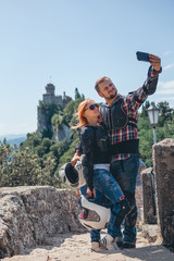 Man and woman couple take a selfie on smartphone. Motorcycle outfit and sunglasses. body protection...