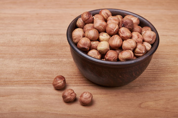 Walnut kernels and whole walnuts on rustic old wooden table