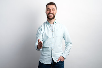 Fototapeta premium Portrait of happy man .holds out his hand for greeting looking at the camera