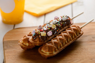 Sweet corn dogs decorated with chocolate, sugar sprinkles and marshmallow