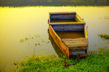 Fototapeta na wymiar old wooden fishing boat moored on the shore