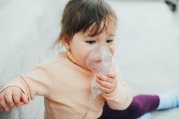 The girl makes an inhalation for coughing on her own