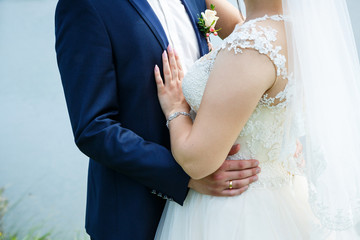 Bride cuddle with groom on wedding day