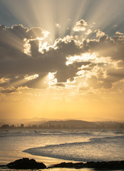Coolangatta being lit by light rays from a beautiful sunset of gold in queensland australia