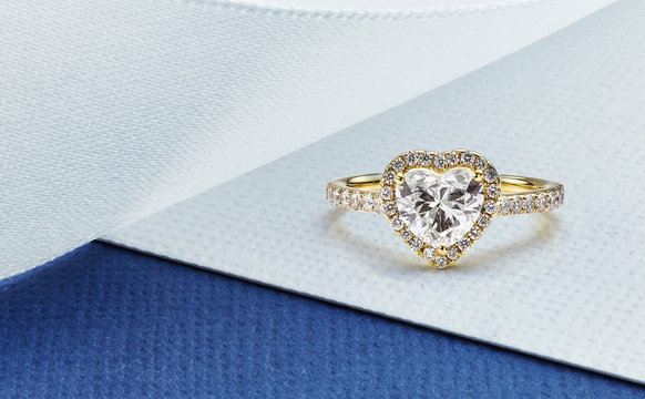 Yellow Gold Heart Shaped Diamond Ring on Blue and White Background