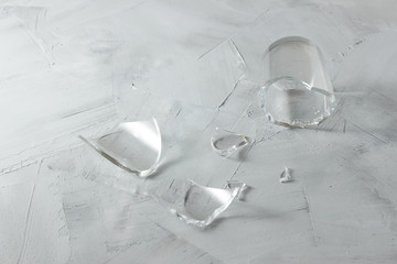 Broken glass on a grey cement background