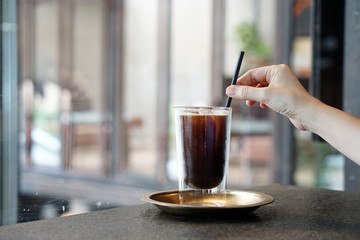 Iced Americano - A glass of black coffee on table and copy space, Brewing espresso and mixed with...