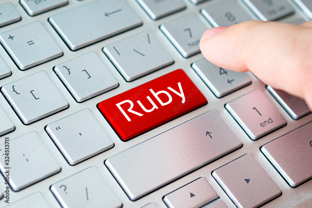 Wall mural button with the ruby on grey keyboard of a modern laptop.