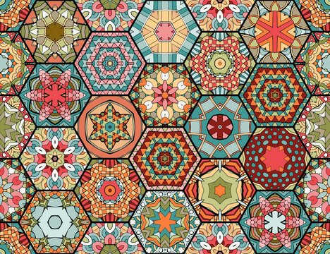Colorful patchwork pattern in ethnic style. Hexagonal ceramic tiles with bright ornament. Seamless vector design.