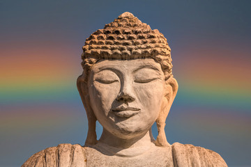 Buddha with Rainbow in a Cloudy Sky