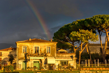 Rainbow and Dark Sky over Old Building in Southern Italy