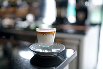 Dirty Coffee - A glass of espresso shot mixed with cold fresh milk on blurred background and copy space, Perfect drink for summer time.