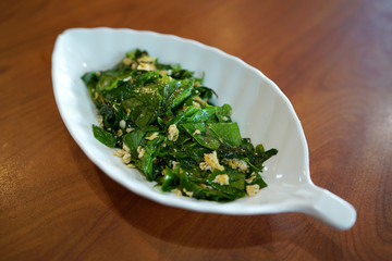 Stir-fried Baegu leaves with egg or Gnetum gnemon or Malindjo, Thai Southern traditional food style.