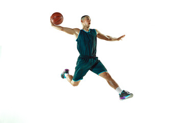 Young basketball player of team wearing sportwear training, practicing in action, motion in jump, flight isolated on white background. Concept of sport, movement, energy and dynamic, healthy lifestyle