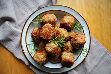 Roasted meatballs , delicious meat cutlets on wooden table . Top view