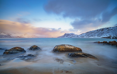 winter landscape at polar dawn on Kvaløya Island and fjord near Tromso, northern Norway