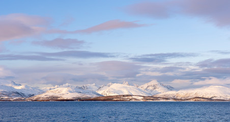 winter landscape at polar dawn on Kval&oslash;ya Island and fjord near Tromso, northern Norway