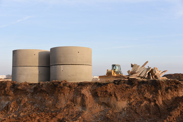 Laying of underground storm sewer pipes in ditch. Installation of water main and sanitary sewer at...